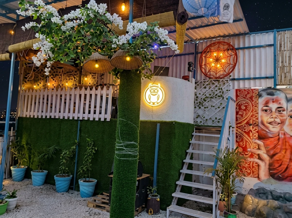 The Owl Cafe terrace lit up with string lights and murals